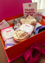 A beautiful pink gift box filled with socks, ready to be gifted to a Pilates, barre, Lagree, or Yoga enthusiast. The packaging for each pair of grip socks read Get a Grip - The grip you need for the moves you love. 